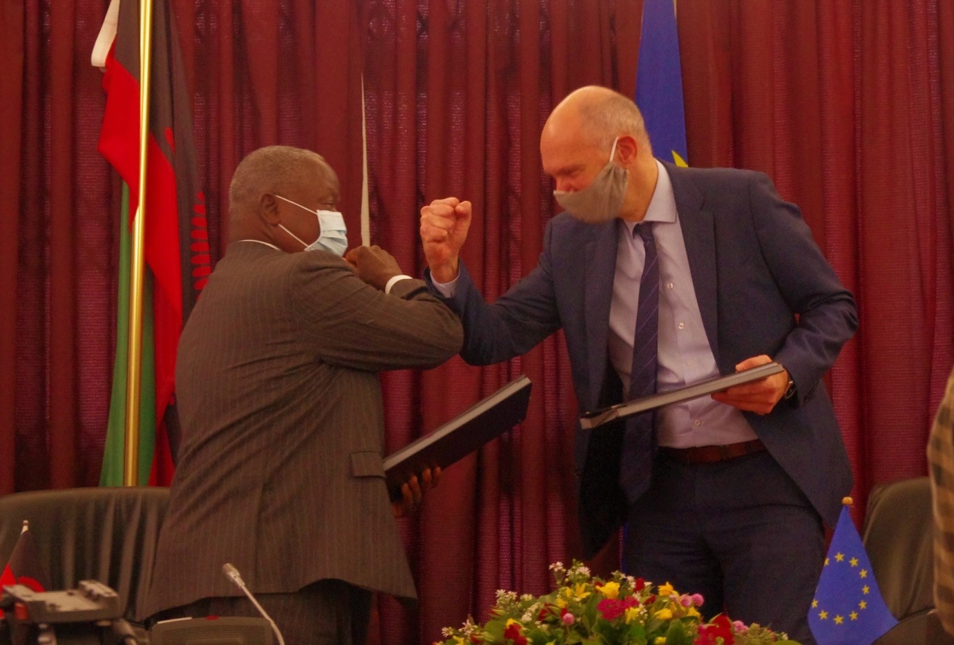 Hon. Felix Mlusu, Minister of Finance and Ivo Hoefkens, EU Head of Cooperation and Charge d’Affaires confidently exchanging signed documents on the Zantchito (Skills for Jobs) Programme